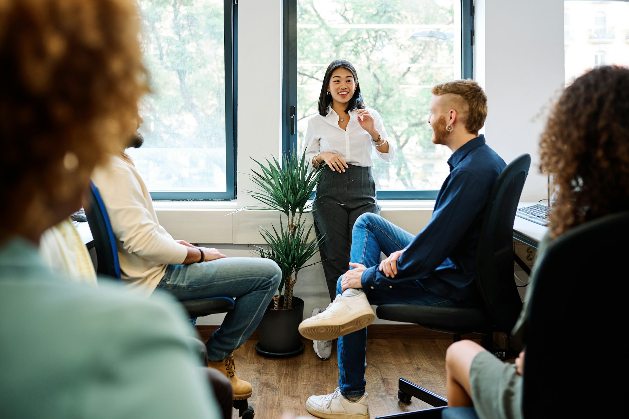 Chinese woman talking during a relaxed meeting on a coworking