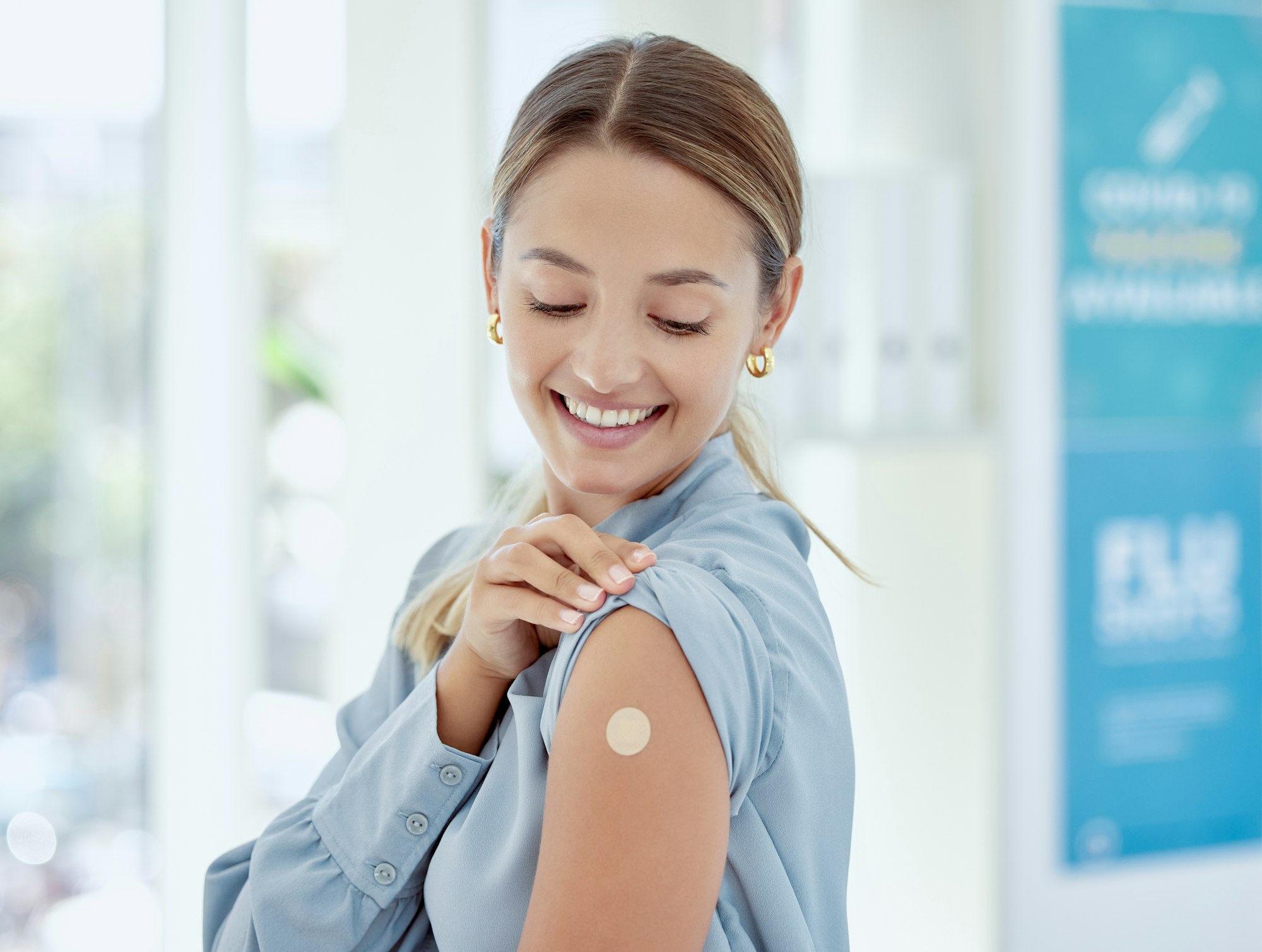 Covid, vaccine and healthcare with a woman sitting in a hospital after getting a shot, booster or m