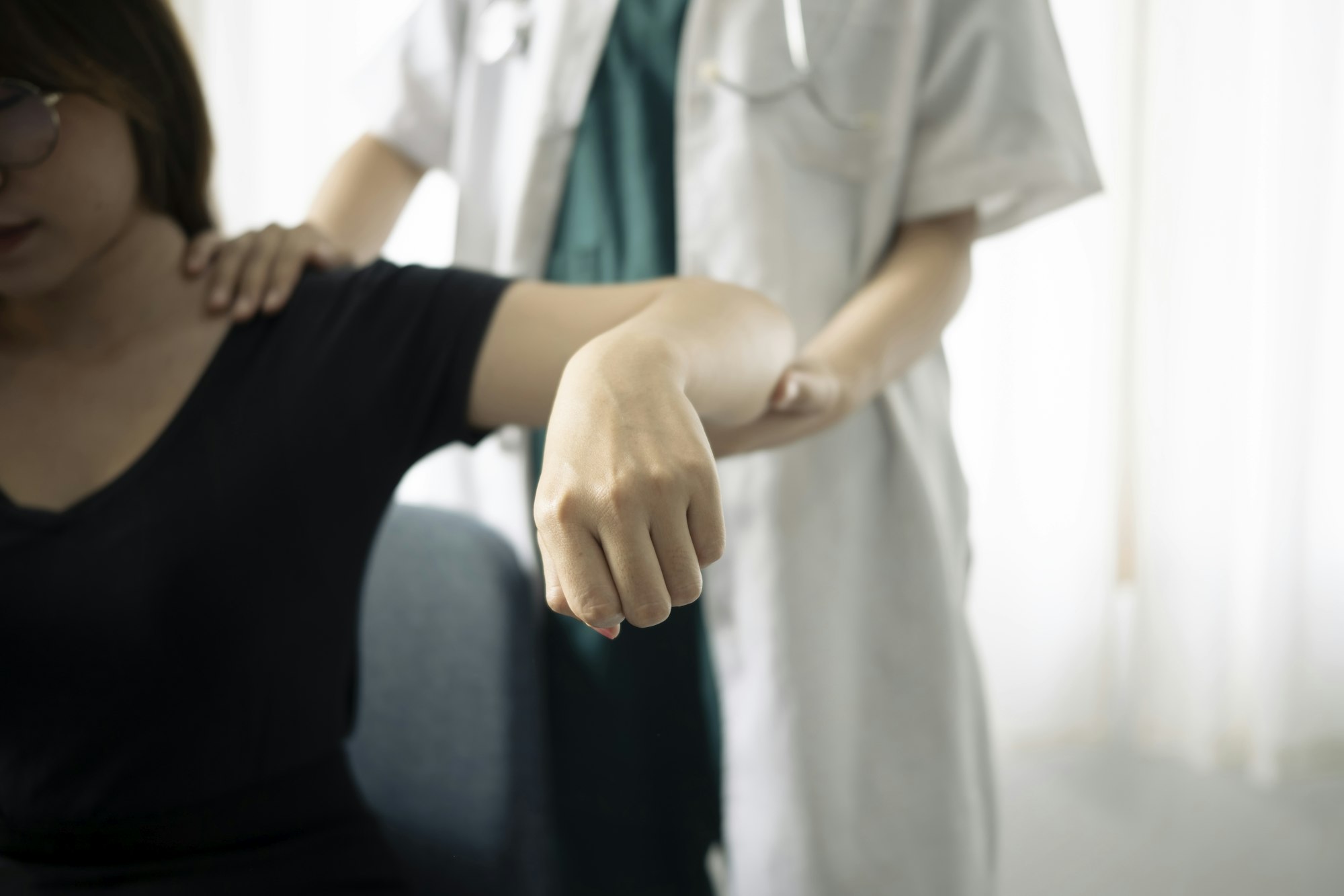 Shot of physiotherapist helping patient to do exercise in physios room.